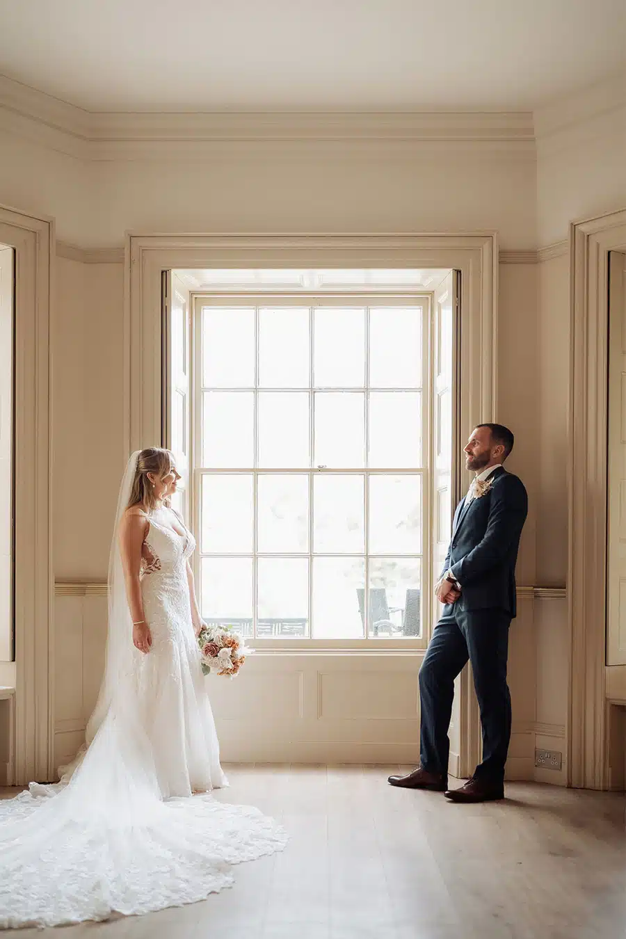Bride & Groom by Window in Lounge of That Amazing Place Essex Wedding Venue