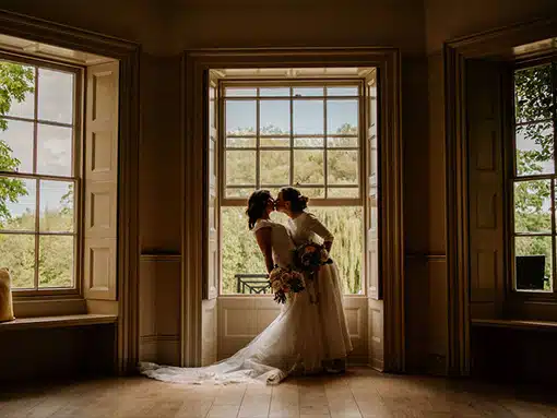 Bride and Bride Lesbian wedding LGTBQ by Lounge sash windows That Amazing Place Essex Wedding Venue with Accommodation