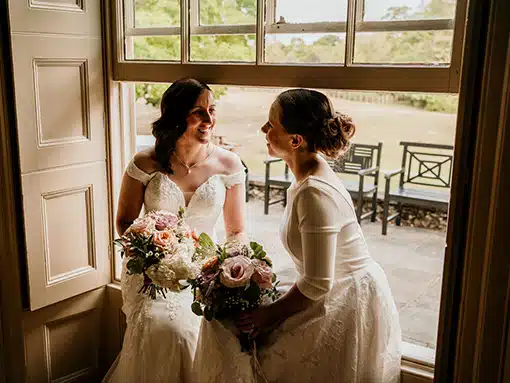 Bride and Bride Lesbian wedding LGTBQ by windows That Amazing Place Essex Wedding Venue with Accommodation
