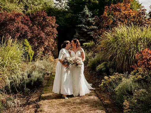Bride and Bride Lesbian wedding LGTBQ secret garden walkway That Amazing Place Essex Wedding Venue with Accommodation