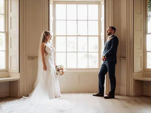 Bride and Groom by Lounge sash windows That Amazing Place Essex Wedding Venue with Accommodation