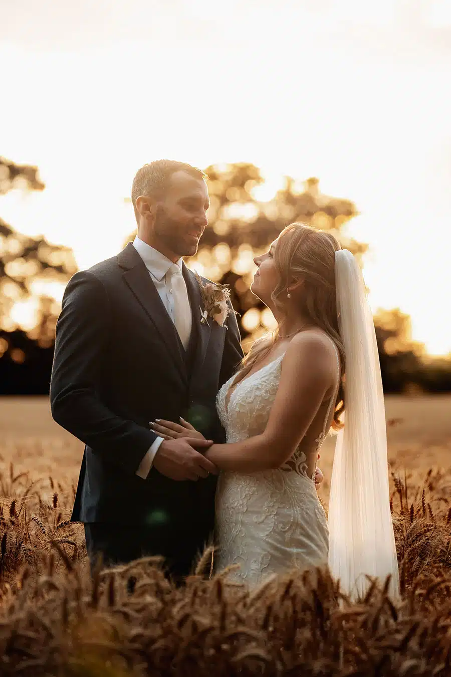 Bride and Groom in corn fields at That Amazing Place Exclusive Essex Wedding Venue with Accommodation by Chris Woodman Photography