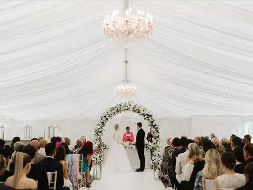Bride and Groom marquee ceremomy with guests at That Amazing Place Exclusive Essex Wedding Venue