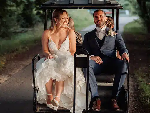 Bride and Groom on golf buggy at That Amazing Place Essex Wedding Venue with Accommodation