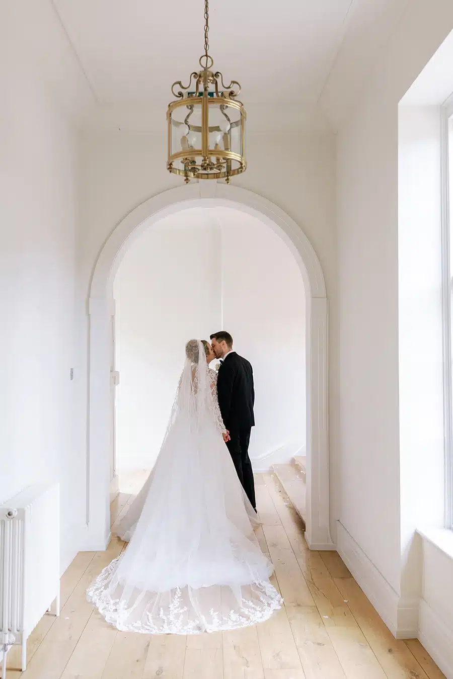 Bride and groom in walkway in house at That Amazing Place Essex Wedding Venue
