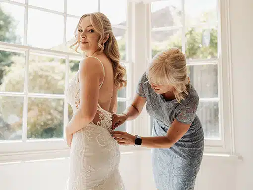 Bride getting her dress on at That Amazing Place Essex Wedding Venue The Lodge Pre Wedding Accommodation