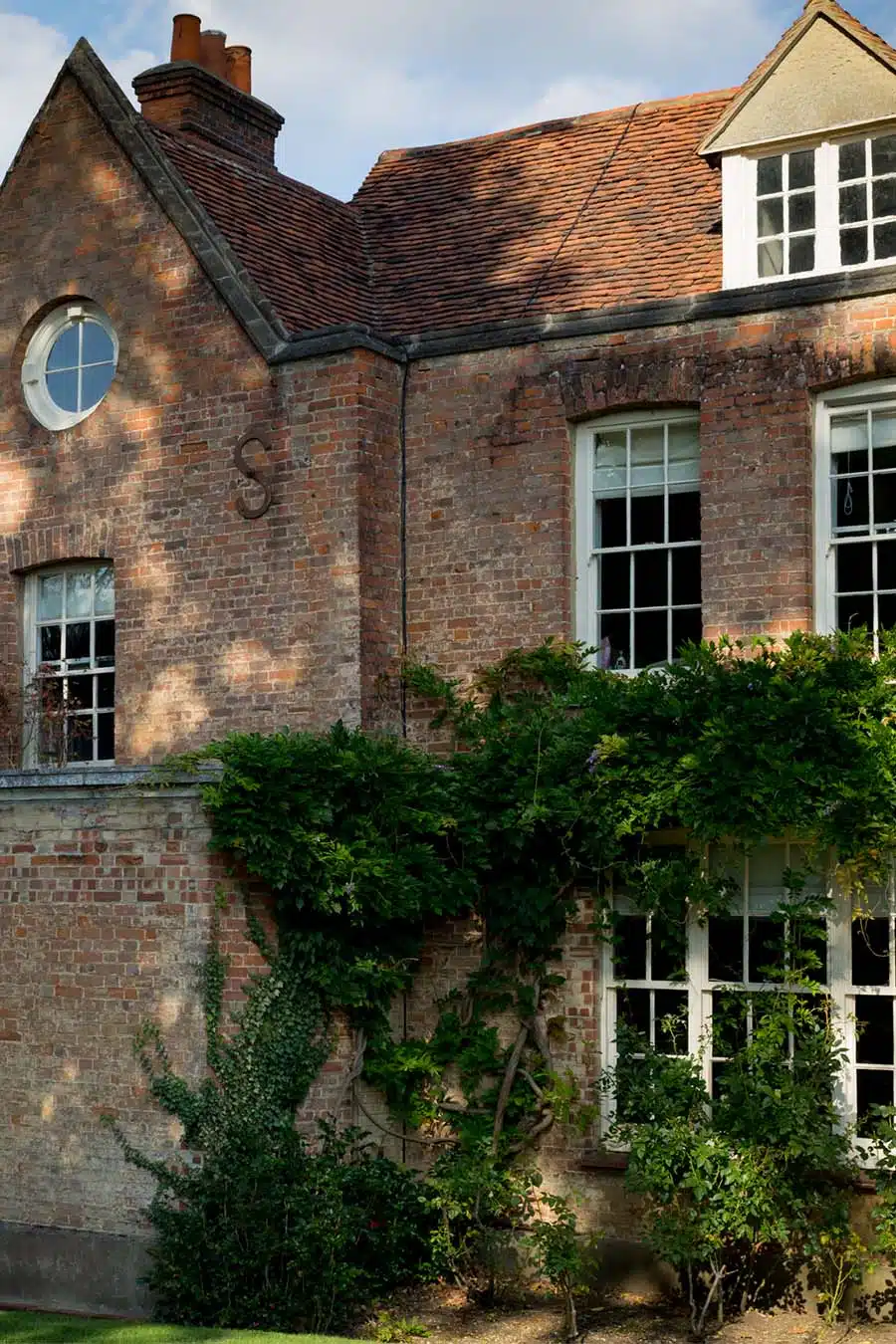 Side of house and wisteria at That Amazing Place Essex Wedding Venue