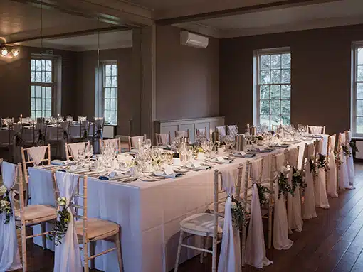 Small wedding setup in the the Hall with long table at That Amazing Place Essex Wedding Venue